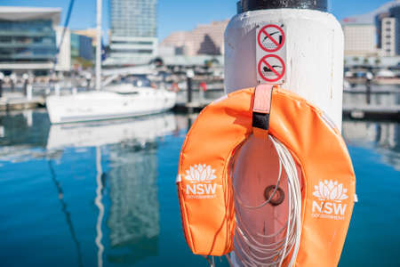 Sydney, Australia - July 23, 2017: Bright orange water protection inflatable lifesaver buoy with NSW government emblem in Darling Harbour in Sydney, Australiaのeditorial素材