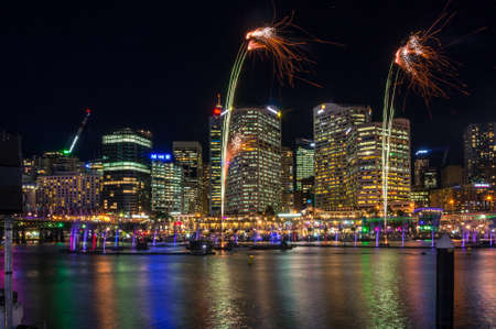 Sydney, Australia - June 9, 2016: Sparkling fireworks in the Darling Harbour with Sydney cityscape on the background. Vivid Sydney festival fireworks light show displayのeditorial素材