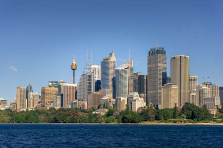Sydney, Australia - July 23, 2016: Business District cityscape with futuristic skyscrapers and park with green trees at harbour foreshore. Sydney, Australiaのeditorial素材