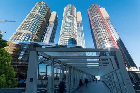 Sydney, Australia - November 24, 2016: People walking to work via pedestrian gallery at Barangaroo precinct with Barangaroo International Towers Sydney on the background. Modern urban lifestyleのeditorial素材