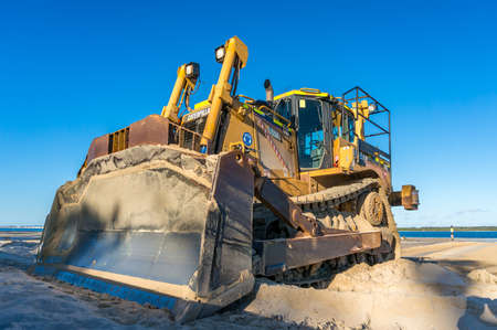 Sydney, Australia - June 18, 2014: Caterpillar crawler heavy duty dozer with metal shovel blade in sand. Construction and landfill equipment and machineryのeditorial素材