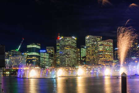 Sydney, Australia - June 9, 2016: Sparkling fireworks in the Darling Harbour with Sydney Central Business District cityscape on the background. Vivid Sydney festival fireworks light show displayのeditorial素材