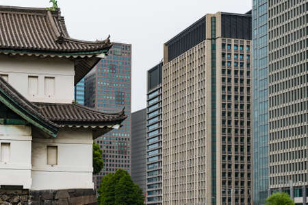 Tokyo, Japan - August 30, 2016: Traditional Japanese building with Asian roof with modern high-rise skyscrapers on the background. Imperial Palace building in Marunouchi suburb of Tokyo, Japanのeditorial素材