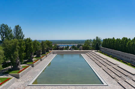Volgograd, Russia - June 9, 2018: View of memorial pool on Mamayev Kurgan war memorial complex in Volgograd city. Cyrillic text commemorates feat of arms of defenders of the Stalingrad cityのeditorial素材