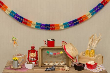 Table decorated to the theme `Festa Junina`. Prepared with sweet and savory foods typical of the Brazilian June festival.の写真素材