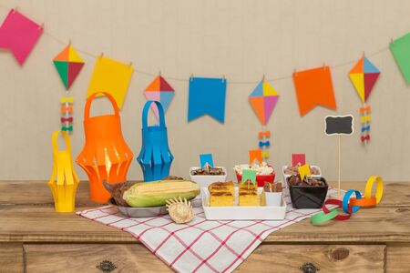 Decorated, colorful and cheerful table with typical sweet and savory foods to celebrate the Brazilian June party. `Festa Junina`.の写真素材