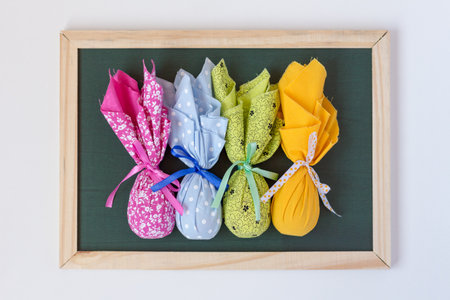 Easter decoration. Beautiful, colorful and cute easter eggs on a blackboard. White background. Top...
