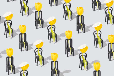 A creative pattern with flowers sitting on a chair on grey background Minimal nature love concept. Mother's day or Valentines idea.の写真素材