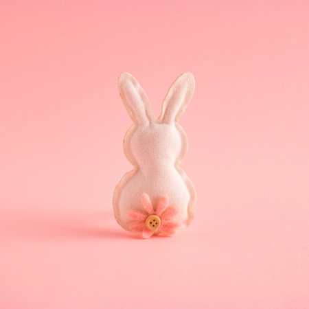 Creative easter bunny or rabbit made of canvas with a flower. Minimal spring Holiday concept. Pastel background.の写真素材