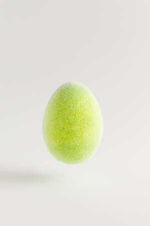 Creative composition with green Easter eggs floating on a gray background. Minimal Spring holidays concept.の写真素材