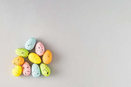 Creative composition with colorful Easter eggs on a gray background. Minimal Spring holidays concept. Creative copy space. Flat lay.の写真素材