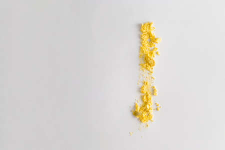 Creative Easter art concept with a trace of natural egg yolk on a white background. Minimal holiday and food conceptの写真素材