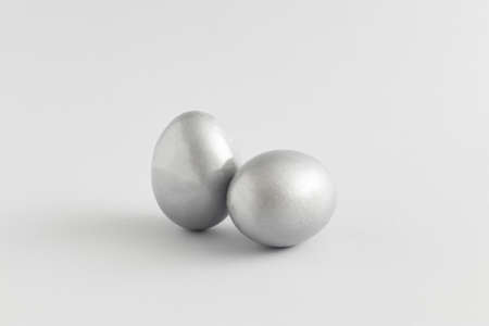 Silver easter egg composition on a gray background. Minimal holiday concept. Flat lay, top view.