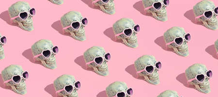 Skull pattern with glasses on pink background. Halloween creative fashion love concept.の写真素材