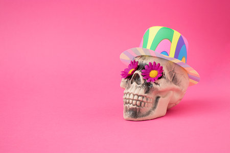 Skull with pink flowers and colorful hat. Halloween background. Santa Muerte concept.の写真素材