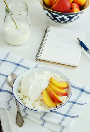 Breakfast with cottage cheese, fresh nectarines and sour cream の写真素材