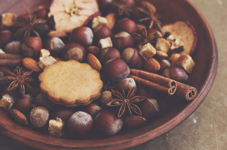 Clay display with gingerbread cookies, spices, nuts and brown sugar
