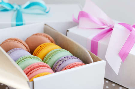 Set of various pastel colored macaroon and gift boxes with ribbon and bowの写真素材