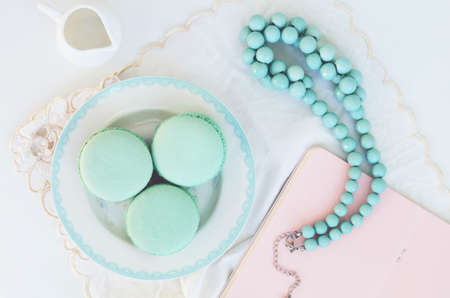 Mint macaroon and teal beads on light backgroundの写真素材