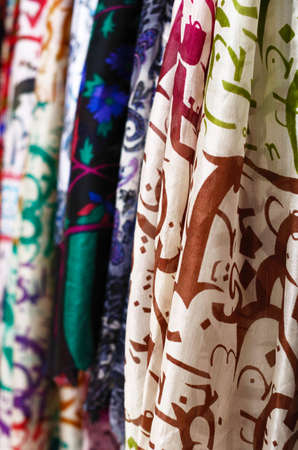 Various ornate silk scarves hanging at street market in Istanbul, selective focus