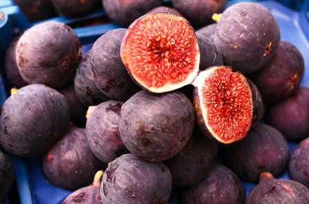 Heap of ripe purple figs at vegetable market