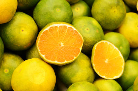 Green mandarin at fruit market, close up