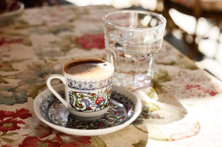 Traditional turkish coffee and glass of water at street cafeの写真素材