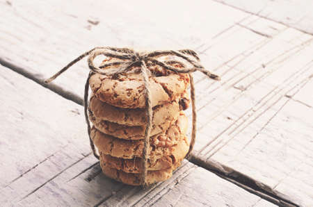Pile of homemade cookies with nuts tide up with jute twineの写真素材