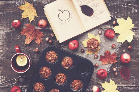 Cozy autumn breakfast - homemade apple muffins and cup of tea with lemon, top viewの写真素材