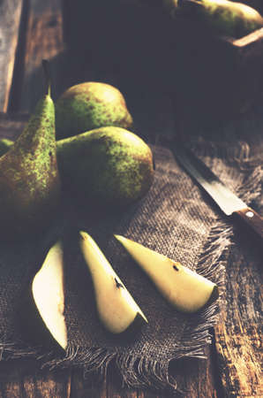 Sliced yellow and green pears in rustic styleの写真素材