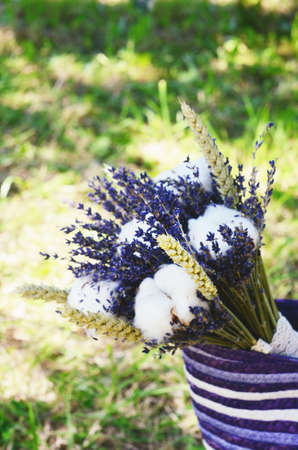 Decoration with dried lavender and cotton bouquet in purple bagの写真素材