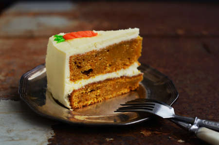 Piece of homemade carrot cake with copy space on rustic dark backgroundの写真素材