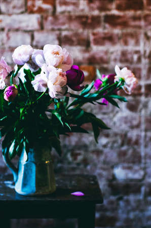 Bunch of peonies in a blue vaseの写真素材