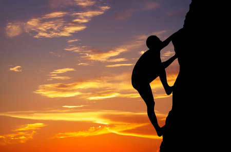 Rock climber at sunset background. Sport and active life の写真素材