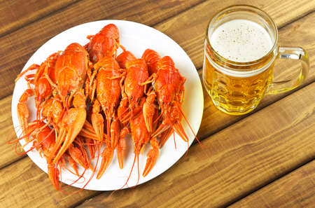 Tasty boiled crayfish and beer on a tableの写真素材