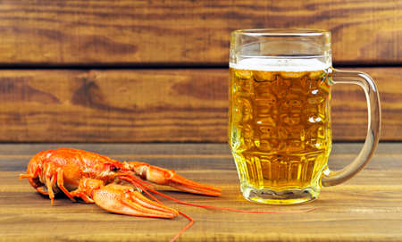 Tasty boiled crayfish and beer on tableの写真素材