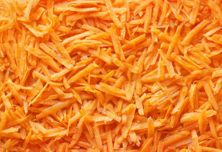 Grated carrot close-up, for backgrounds or textures.の写真素材