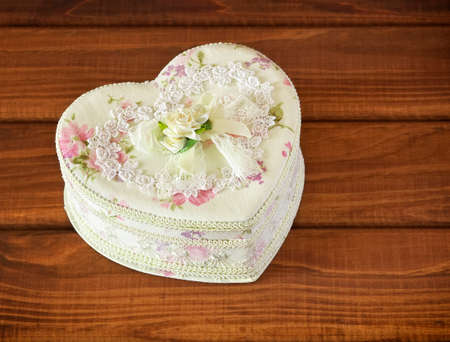 Gift box in a form of heart on wooden の写真素材