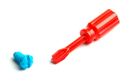 Toy plastic screwdriver and screw on a white backgroundの写真素材