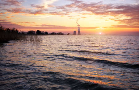 Beautiful landscape with reservoir, sunset sky and power plant.の写真素材