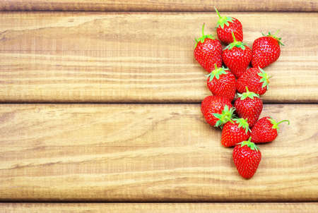 Ripe strawberries on wooden table. Fresh strawberries on wooden backgroundの写真素材