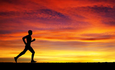 Running man on apocalyptic sunset skyの写真素材
