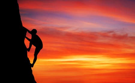 Rock climber at sunset background.の写真素材