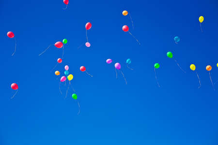 Lots of colorful balloons flying on blue sky
