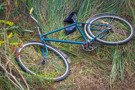 Old Soviet bike lying on the grassの写真素材