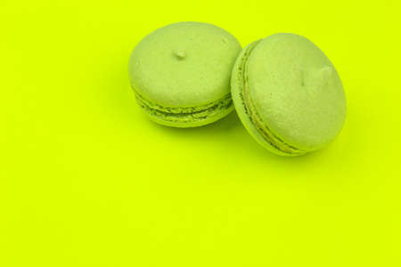 Tasty green macaroons on green backgroundの写真素材