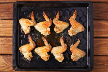 Tasty grilled chicken wings on baking sheetの写真素材