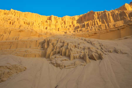 Beautiful sand pit with lines on the golden sand and blue sky.