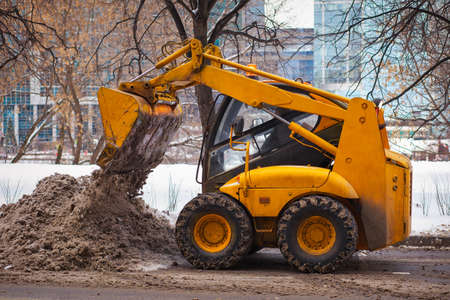 Snowblower vehicle removes snow from the roadの写真素材