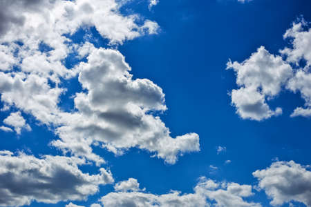 Blue sky background with fluffy clouds
